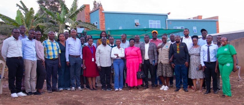 Participants at the training join farmers in the outskirts of Kigali, where an Azolla facility was established